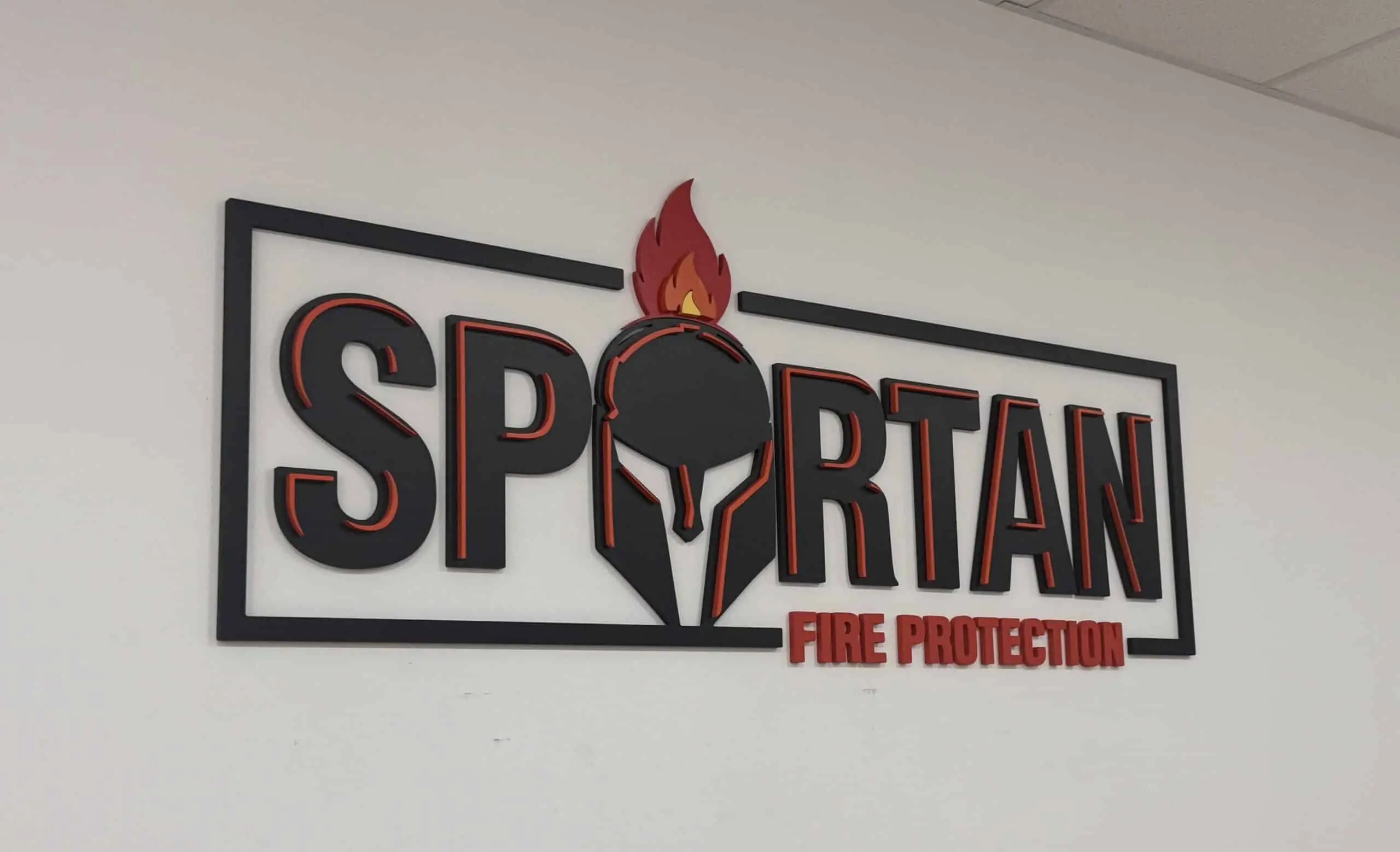 Spartan Fire Protection logo featuring a flame and helmet design, emphasizing fire safety and monitoring services in Houston.