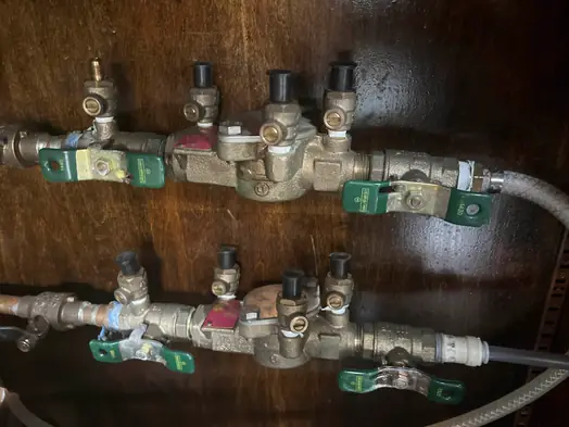 Two backflow preventers on soda fountain water lines