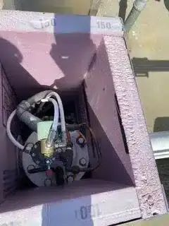 Open enclosure showing a backflow valve inside